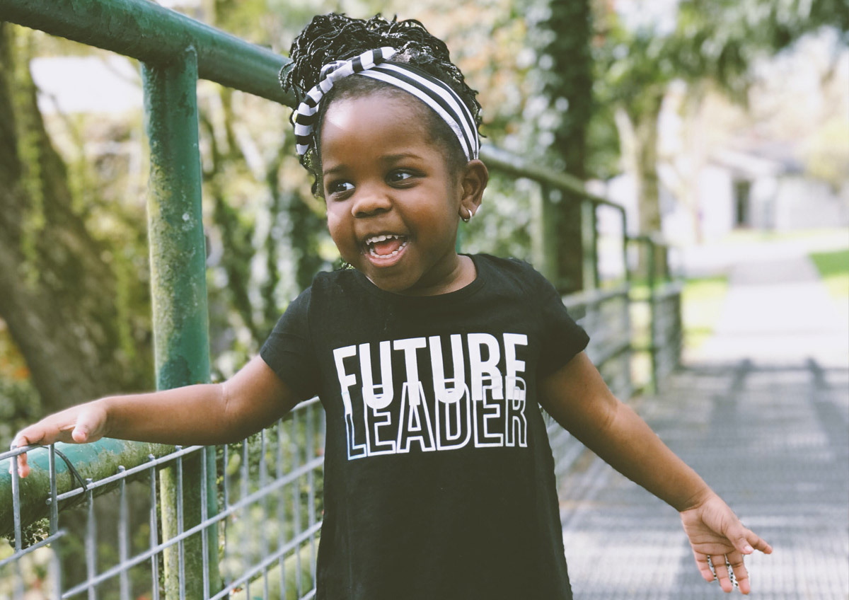 child wearing "future leader" shirt