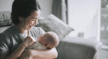 woman bottle feeding a baby