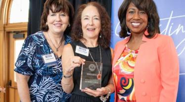 women holding awards