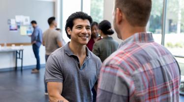 Veteran shaking hands with a person at a career event.